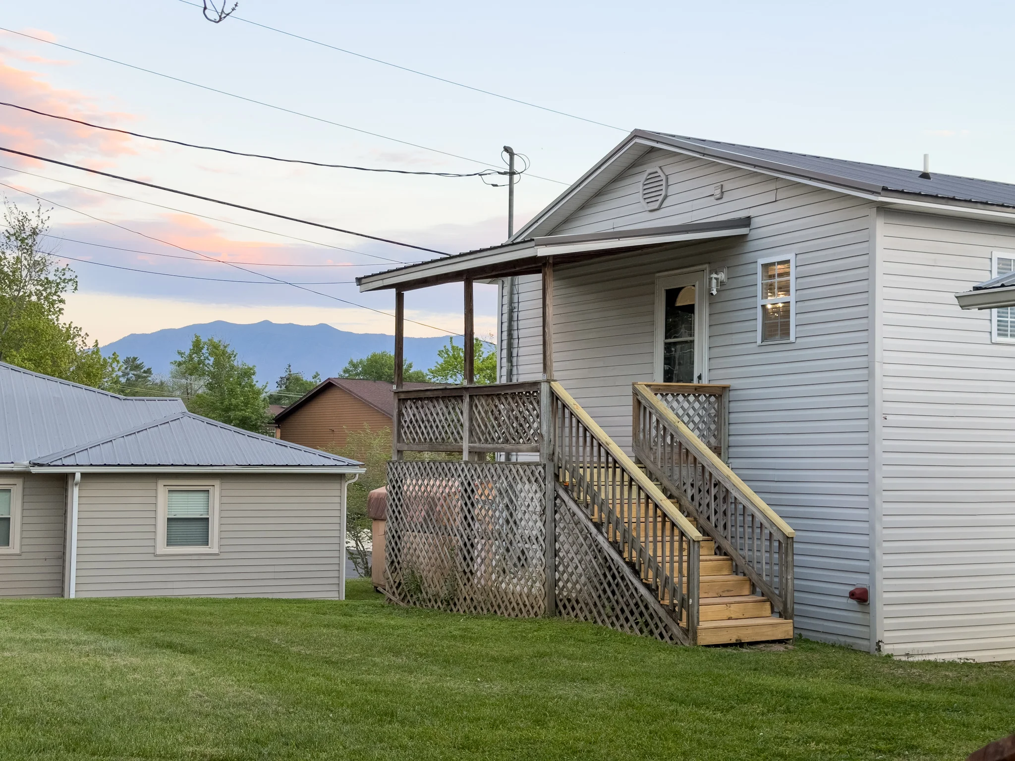 Exterior view of 522 Oldham St with Smoky Mountains in the background at dusk